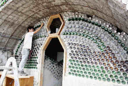 A guy building an Earthship house made of tyres and bottles